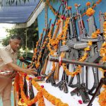 A policeman offers prayers to weapons at a police headquarters to mark Dussehra in Ahmedabad, Gujarat, on October 11, 2016.