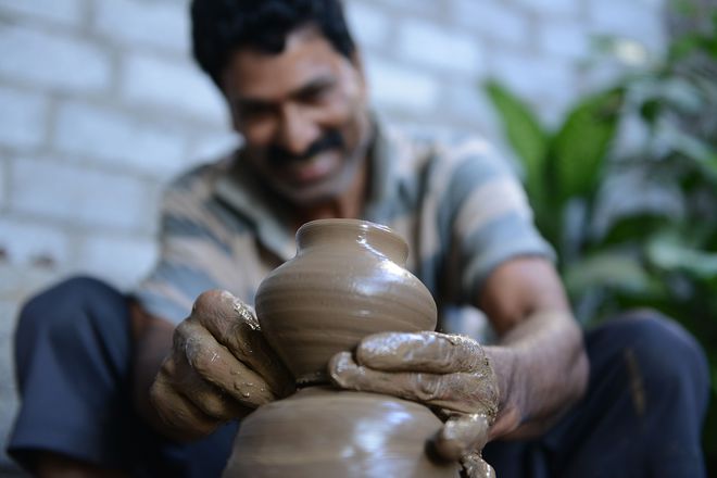 A potter makes earthenware oil pots or diyas at a workshop, ahead of the forthcoming Diwali festival, the Hindu festival of lights, on the outskirts of Hyderabad on October 21, 2016.