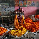 A vendor sells marigold garlands, which are used to decorate temples and homes during the Hindu festival of Durga Puja, at a wholesale flower market in Kolkata on October 6, 2016.