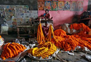 A vendor sells marigold garlands, which are used to decorate temples and homes during the Hindu festival of Durga Puja, at a wholesale flower market in Kolkata on October 6, 2016.