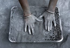 A worker fills small paper rolls with gunpowder mixture to make firecrackers at a factory ahead of Diwali, the Hindu festival of lights, on the outskirts of Ahmedabad, India October 21, 2016.