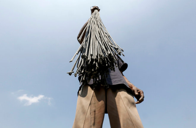 A worker holds wicks, which are used to make firecrackers, to dry at a factory ahead of Diwali, the Hindu festival of lights, on the outskirts of Ahmedabad on October 21, 2016.