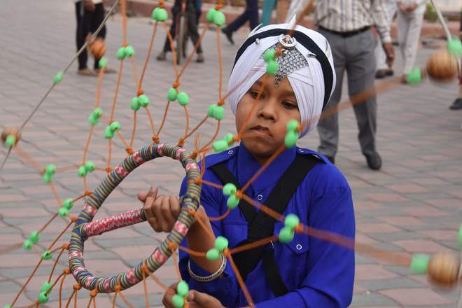 A young Sikh devotee performs gatka at the Golden Temple in Amritsar on November 12, 2016, on the eve of the 547th birth anniversary of Guru Nanak Dev.