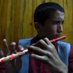 An Afghan music student plays the flute during a practice session at the Afghanistan National Institute of Music in Kabul.