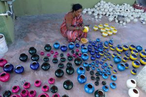 An artist applies colour to earthenware oil pots or diyas at a workshop, ahead of the forthcoming Diwali festival, the Hindu festival of lights, on the outskirts of Hyderabad on October 21, 2016.