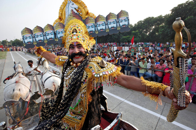 An artiste dressed as demon king Ravana acts in a religious play during Vijaya Dashmi, or Dussehra festival celebrations in Chandigarh on October 11, 2016.