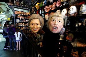 An employee holds up masks depicting Democratic presidential nominee Hillary Clinton and Republican presidential nominee Donald Trump at Hollywood Toys & Costumes in Los Angeles, California, US, on October 26, 2016.