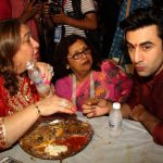 Bollywood actor Ranbir Kapoor (R) has Bhog — sacred food — during celebrations at the North Bombay Sarbojanin Durga Puja in Mumbai on October 9, 2016.