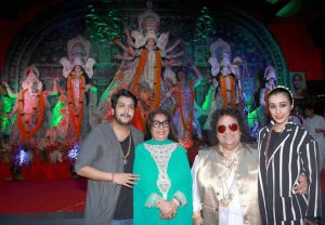 Bollywood music composer Bappi Lahiri attends at the North Mumbai Sarvajanik Durga Pooja Pandal with family during the Durga Puja celebrations Navratri celebration in Mumbai on October 7, 2016.