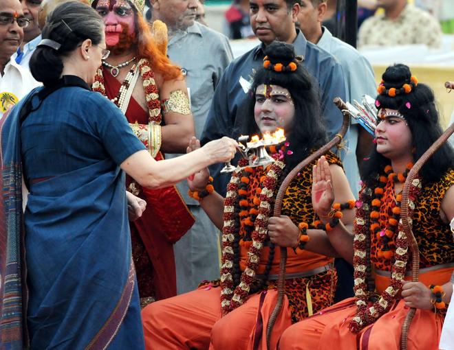 Congress President Sonia Gandhi performs an 'aarti', a ritual of worship, to artistes playing Lord Ram and Laxman during Dussehra celebrations of Shri Dharmic Leela Committee at the Red Fort in New Delhi on October 11, 2016.