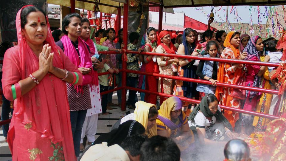 Devotees offer prayers inside the historical Kali Mata Temple on the first day of the Navratri festival in Jammu