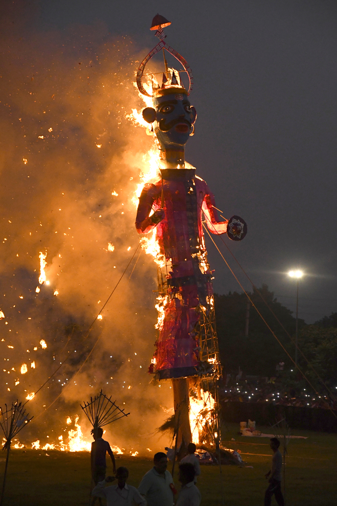 Hindu devotees burn an effigy of demon king Ravana as they celebrate the Hindu festival of Dussehra in Panchkula on October 11, 2016.