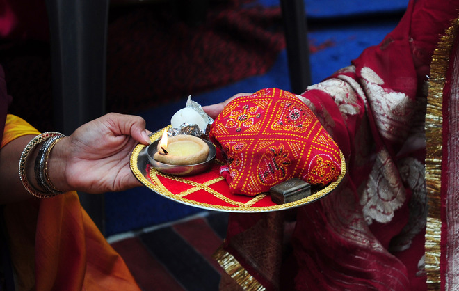 Hindu wives perform rituals during the Karwa Chauth festival at a Rama temple in Allahabad on October 19, 2016. Karwa Chauth is a traditional Hindu festival celebrated in northern India during which married women fast one whole day and offer prayers to the moon for the welfare, prosperity, and longevity of their husbands.
