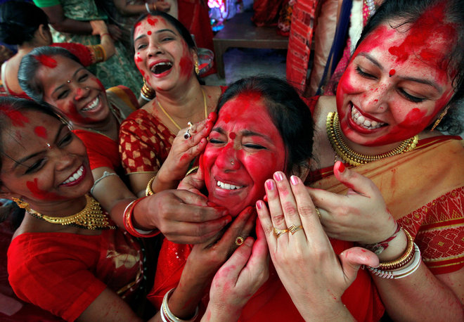 Hindu women apply ‘sindhoor’, or vermillion powder, on the face of a woman as part of a ritual known as ‘Sindhoor Khela’ as they mark the Dusshera-Vijaya Dashami festival in Chandigarh, India, on October 11, 2016. The Sindhoor Khela is a ritual carried out by married women to wish one another a long married life.