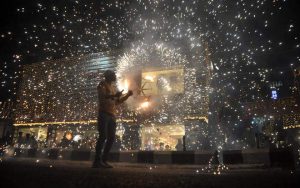 In this photograph taken on October 27, 2016, an Indian worker bursts firecrackers during a fireworks display at a local marketplace on the eve of Diwali festival in Jammu.