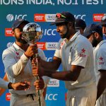 India’s Virat Kohli (L) and Ravichandran Ashwin (R) hold the ICC best test team trophy after winning the Test series against New Zealand at the Holkar Cricket Stadium in Indore on October 11, 2016.