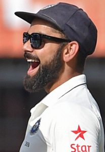 India’s Virat Kohli (R) celebrates the wicket of New Zealand’s batsman Mitchell Santner during the fourth day of third Test cricket match between the two teams at the Holkar Cricket Stadium in Indore on October 11, 2016.