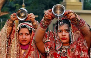 Married women perform a ritual for the well being of their husbands during the Hindu festival of Karva Chauth inside a temple in Chandigarh on October 19, 2016.