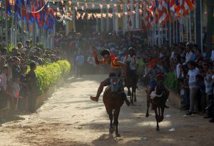 Men ride horses during the Pchum Ben festival, in Vihear Sour village in Kandal province, Cambodia, on October 1, 2016.