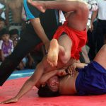 Men wrestle during the Pchum Ben festival, in Vihear Sour village in Kandal province, Cambodia, on October 1, 2016.