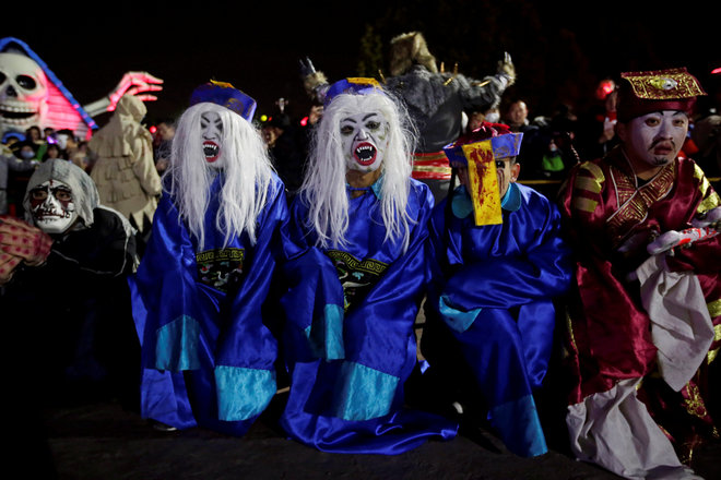 Performers wait to attend a Halloween parade at Happy Valley park in Beijing, China, on October 31, 2016.