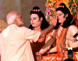 Prime Minister Narendra Modi applies ‘tilak’, or a holy mark, on artistes enacting Lord Rama and Lakshman during Dussehra celebrations at Aishbagh Ram Leela in Lucknow, Uttar Pradesh, on October 11, 2016.
