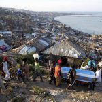 Residents carry a coffin containing the remains of a pregnant woman, a victim of Hurricane Matthew, in Jeremie, Haiti, on October 7, 2016.