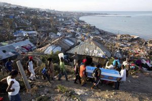 Residents carry a coffin containing the remains of a pregnant woman, a victim of Hurricane Matthew, in Jeremie, Haiti, on October 7, 2016.
