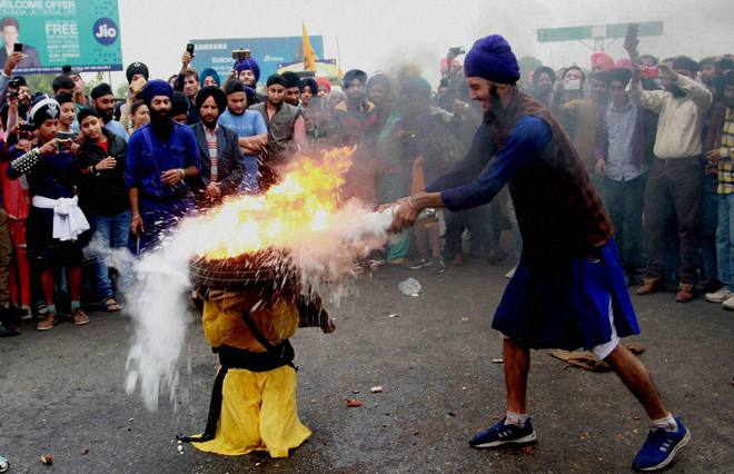 Sikh devotees take part in a gatka martial arts demonstration in a Nagar Kirtan procession in Jammu on November 12, 2016 on the eve of the 547th birth anniversary of Guru Nanak Dev.