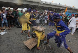 Sikh devotees take part in a gatka martial arts demonstration in a Nagar Kirtan procession in Jammu on November 12, 2016 on the eve of the 547th birth anniversary of Guru Nanak Dev.