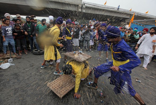 Sikh devotees take part in a gatka martial arts demonstration in a Nagar Kirtan procession in Jammu on November 12, 2016 on the eve of the 547th birth anniversary of Guru Nanak Dev.