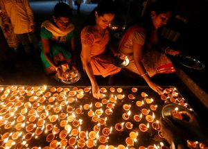 Tamil devotees lights oil lamps at a religious ceremony during the Diwali or Deepavali festival at Ponnambalavaneshwaram Hindu temple in Colombo, Sri Lanka, on October 29, 2016.