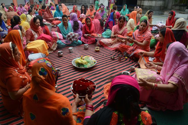 Women gather for a prayer event during the Karva Chauth (Husbands Day) festival at a temple in Amritsar on October 19, 2016.