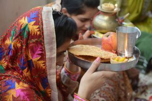 Women gather for a prayer event during the Karva Chauth festival at a temple in Amritsar on October 19, 2016.