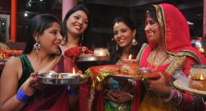 Women perform rituals during the Karwa Chauth festival at a temple in Mohali OCtober 19, 2016.