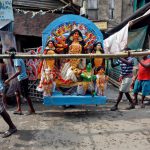 Workers carry an idol of the Hindu goddess Durga through a street towards a pandal, or a temporary platform, ahead of the Durga Puja festival in Kolkata on October 5, 2016.