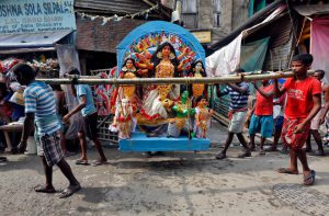 Workers carry an idol of the Hindu goddess Durga through a street towards a pandal, or a temporary platform, ahead of the Durga Puja festival in Kolkata on October 5, 2016.