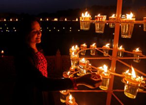 A devotee lights lamps at the Akshardham temple during celebrations on the eve of Diwali, the Hindu festival of lights, in Gandhinagar.