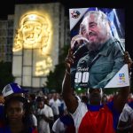 A man holds a poster of late Cuban revolutionary leader Fidel Castro as Cubans gather at the Revolution Square to pay homage to him, in Havana, on November 29, 2016. Castro’s ashes will go on a four-day island-wide procession starting Wednesday before being buried in the southeastern city of Santiago de Cuba on December 4.