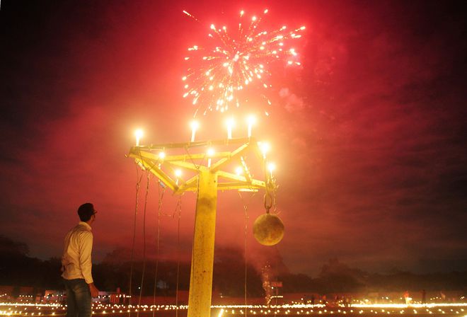 An athlete watches fireworks at the Madan Mohan Malviya stadium on the eve of the Hindu festival of Diwali in Allahabad.