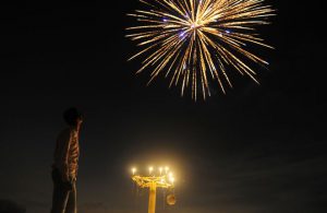 An athlete watches fireworks at the Madan Mohan Malviya stadium on the eve of the Hindu festival of Diwali in Allahabad. Diwali, the Festival of Lights, marks victory over evil and commemorates the time when Hindu god Lord Rama achieved victory over Ravana and returned to his kingdom Ayodhya.