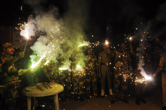 Border Security Force soldiers light candles and crackers during Diwali celebrations at the India-Bangladesh border post of Lankamura, about 5 kilometers from Agartala on Saturday.