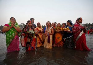 Devotees worship the Sun god in the waters of the Arabian Sea during Chhath Puja in Mumbai