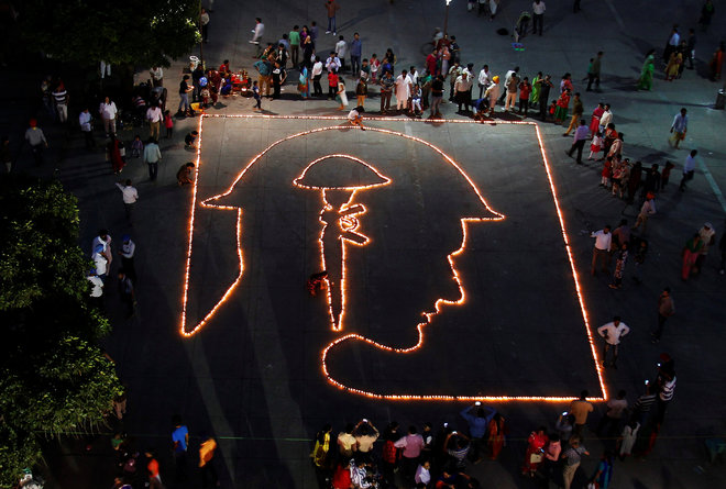 People light lamps arranged to form a tribute to fallen soldiers of the Indian Army in Chandigarh.
