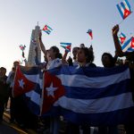 People react while watching a military vehicle transport the ashes of Cuba’s late President Fidel Castro at the start of a three-day journey to the eastern city of Santiago, in Havana, Cuba, on November 30, 2016. Castro’s ashes will go on a four-day island-wide procession starting Wednesday before being buried in the southeastern city of Santiago de Cuba on December 4.