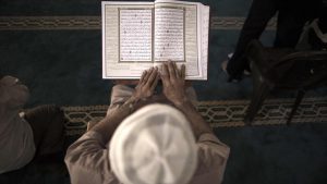 A Palestinian man reads a copy of the Koran, Islam's holiest book, at the al-Omari mosque in Gaza City.