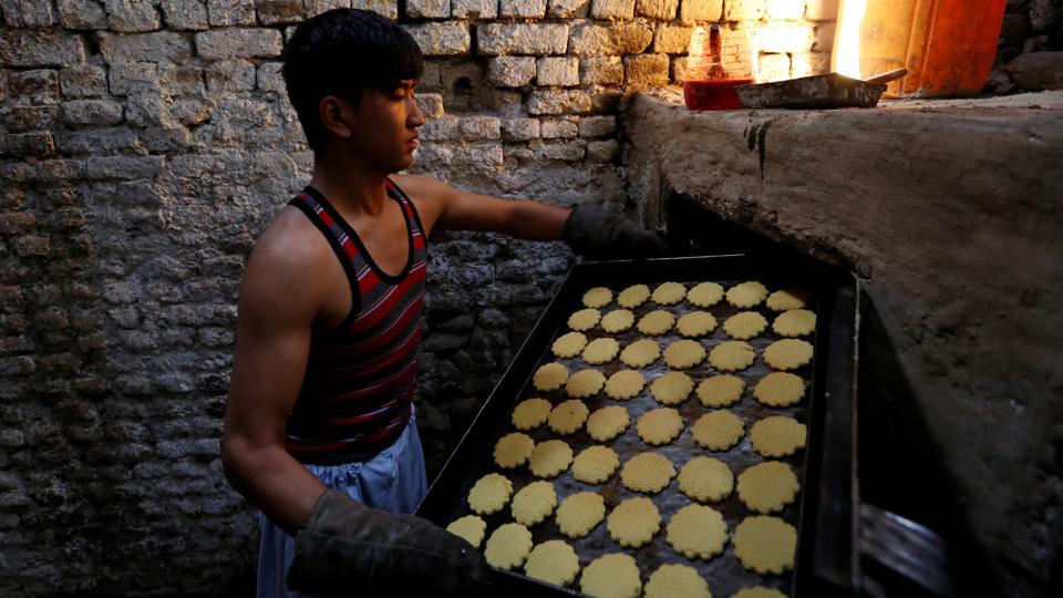 A boy prepares cookies at a small traditional factory in Kabul, Afghanistan.