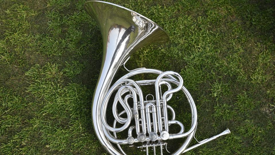 A closeup of a French Horn musical instrument used by the bands