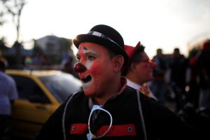 A clown participates in a parade during Salvadoran Clown Day celebrations in San Salvador, El Salvador, December 7, 2016