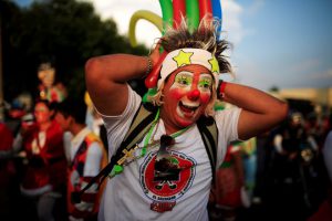 A clown participates in a parade during Salvadoran Clown Day celebrations in San Salvador, El Salvador, December 7